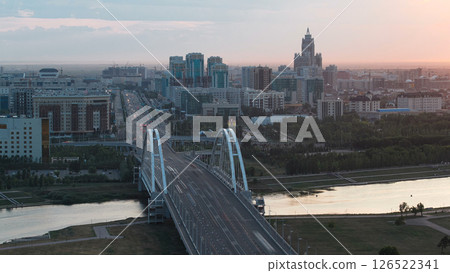 Sunset timelapse above the Bridge with the transport and clouds on the background. Central Asia, Kazakhstan, Astana 126522341