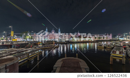 Panorama showing illuminated Central Railway station night timelapse. Amsterdam, The Netherlands Panorama showing illuminated Central Railway station night timelapse. Amsterdam, The Netherlands 126522436