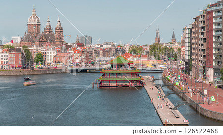 Aerial cityscape panorama with the Basilica of Saint Nicholas in Amsterdam's Old Centre near the Central Station timelapse. 126522468