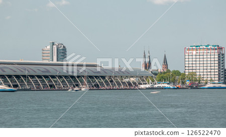 Close up view of Amsterdam Central Station with its curved roof and the Amstel River timelapse. Amsterdam, Netherlands 126522470