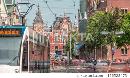 Damrak Street heading from Dam Square to Centraal Station in a timelapse with electric tram. Amsterdam, Netherlands Damrak Street heading from Dam Square to Centraal Station in a timelapse with electric tram. Amsterdam, Netherlands 126522473