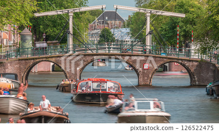 Timelapse of a busy canal boat trip in Amsterdam's city center on a sunny day. Amsterdam, Netherlands 126522475