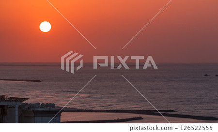 Sunset in Ajman aerial view from rooftop timelapse. United Arab Emirates. 126522555