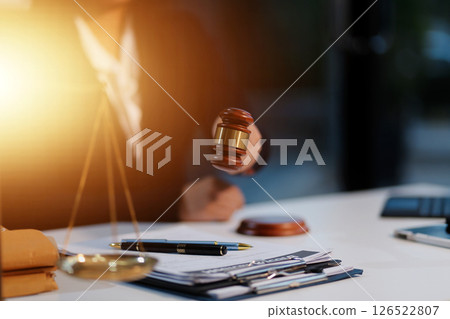 Judge gavel with Justice lawyers having team meeting at law firm background. Concepts of Law and Legal services. Judge gavel with Justice lawyers having team meeting at law firm background. Concepts of Law and Legal services. 126522807