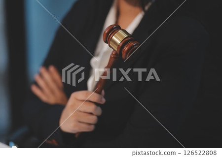 Judge gavel with Justice lawyers having team meeting at law firm background. Concepts of Law and Legal services. 126522808