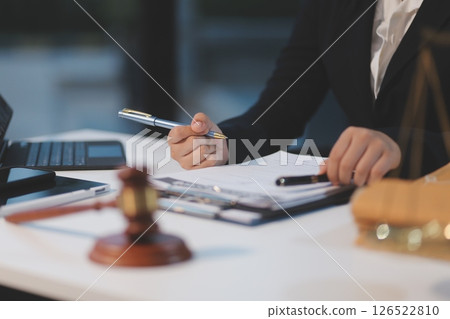 Judge gavel with Justice lawyers having team meeting at law firm background. Concepts of Law and Legal services. 126522810