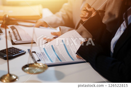 Judge gavel with Justice lawyers having team meeting at law firm background. Concepts of Law and Legal services. Judge gavel with Justice lawyers having team meeting at law firm background. Concepts of Law and Legal services. 126522815