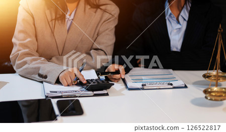 Judge gavel with Justice lawyers having team meeting at law firm background. Concepts of Law and Legal services. Judge gavel with Justice lawyers having team meeting at law firm background. Concepts of Law and Legal services. 126522817