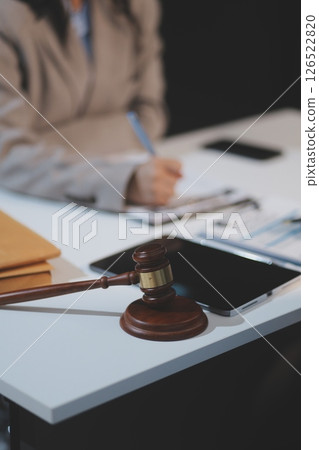 Judge gavel with Justice lawyers having team meeting at law firm background. Concepts of Law and Legal services. Judge gavel with Justice lawyers having team meeting at law firm background. Concepts of Law and Legal services. 126522820