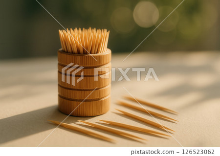 Bamboo Toothpick Holder with Scattered Toothpicks and Bokeh Sunlight 126523062