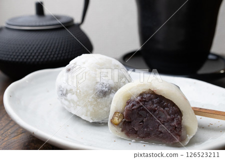 A bean daifuku cut in half on a white plate A bean daifuku cut in half on a white plate 126523211