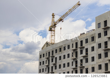Industrial crane next to the building under construction 126523861