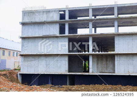 Concrete structure under construction in urban area industrial setting unfinished architecture bleak surroundings. 126524395