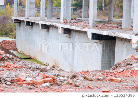 Reveals large concrete structure undergoing construction demolition surrounding debris includes bricks rubble, creating desolate atmosphere. 126524396