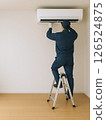 Male worker repairing an air conditioner 126524875