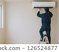 Male worker repairing an air conditioner 126524877