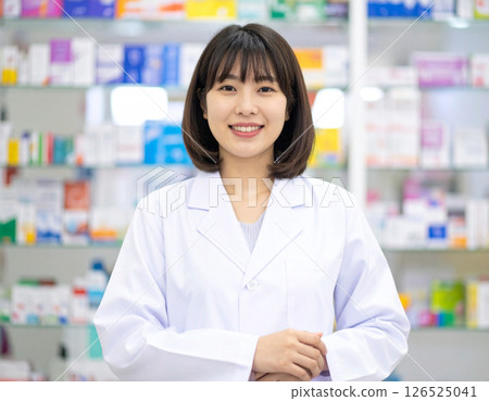 Smiling female pharmacist in a pharmacy 126525041