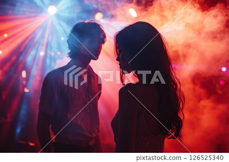 Silhouette of couple in colorful nightclub scene 126525340