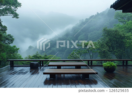 Picturesque view of the mountains from a wooden terrace in foggy weather 126525635