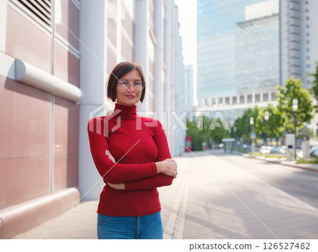 Woman in glasses stands in center of Frankfurt, 126527482