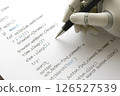 Image of a robot's hand writing a program 126527539