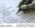 Image of a robot's hand writing a program 126527540