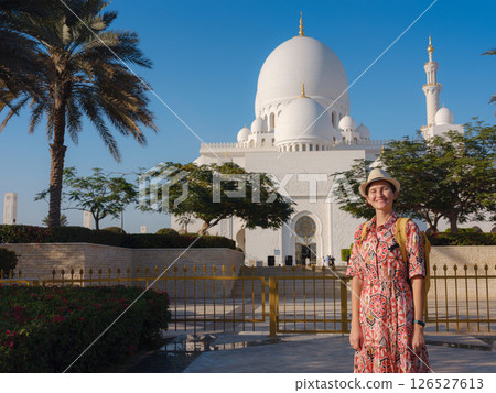 Young female tourist exploring iconic landmarks of the United Arab Emirates. Young female tourist exploring iconic landmarks of the United Arab Emirates. 126527613