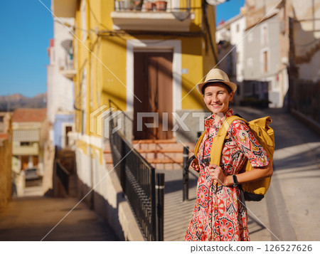 Woman strolls through colorful streets of Spanish coastal town 126527626