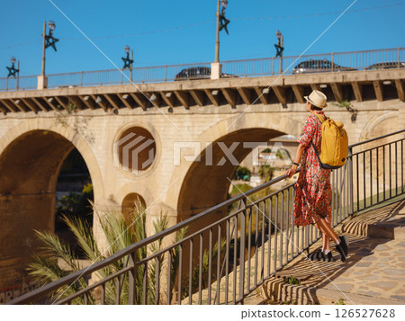 Woman strolls through colorful streets of Spanish coastal town 126527628