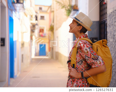 Woman strolls through colorful streets of Spanish coastal town 126527631