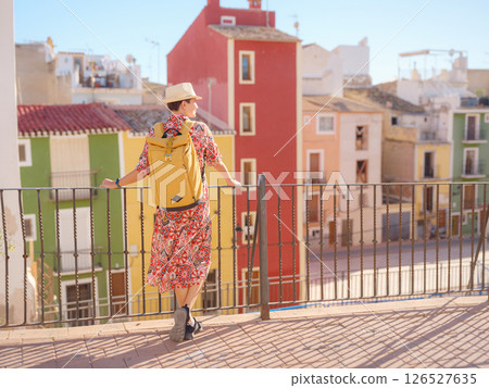 Woman strolls through colorful streets of Spanish coastal town Woman strolls through colorful streets of Spanish coastal town 126527635