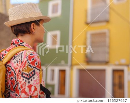 Woman strolls through colorful streets of Spanish coastal town 126527637