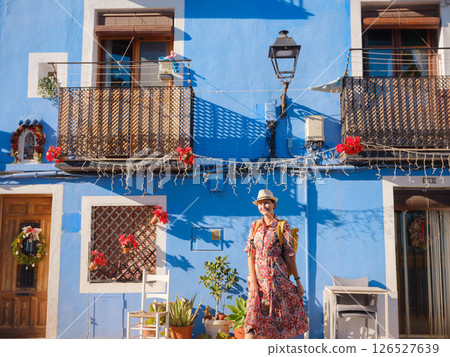 Woman strolls through colorful streets of Spanish coastal town 126527639