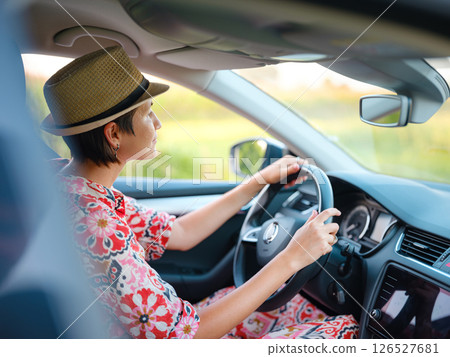 Traveler woman drives car through scenic countryside of Croatia 126527681