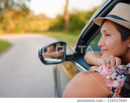 Traveler woman drives car through scenic countryside of Croatia 126527684