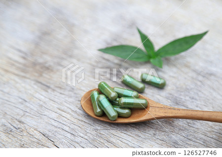 Herbal capsules from green herbal on leaf for healthy eating in daily life 126527746