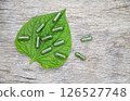Herbal capsules from green herbal on leaf for healthy eating in daily life 126527748