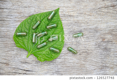 Herbal capsules from green herbal on leaf for healthy eating in daily life 126527748