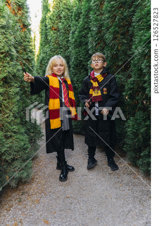 Children Harry Potter Costumes Maze - Two children dressed as Harry Potter characters stand in a maze. Children Harry Potter Costumes Maze - Two children dressed as Harry Potter characters stand in a maze. 126527823