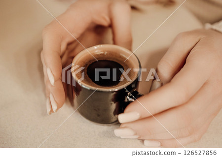 Coffee Cup Hands Cozy Cafe: Woman enjoying espresso indoors, relaxation moment. 126527856