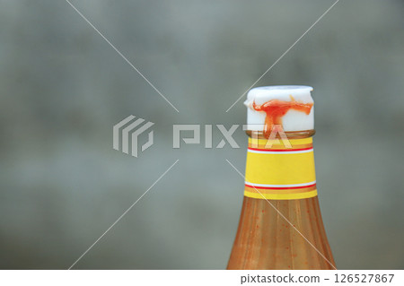 close up view of dirty tomato bottle cap with sauce from using in daily life 126527867