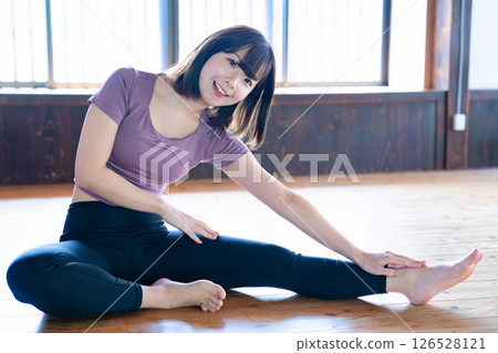 A young woman stretching A young woman stretching 126528121