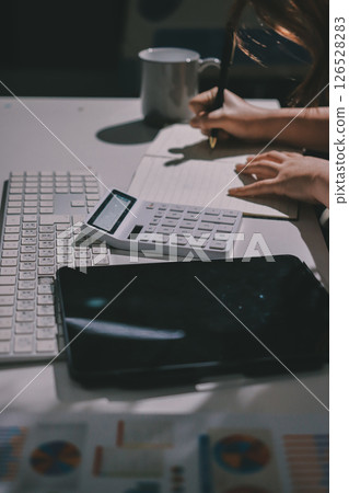 Expert woman asian female people review data number costing managerial account prepare monthly actual cost variance report at tax audit office. ESG sheet budget control ERP process service project. 126528283