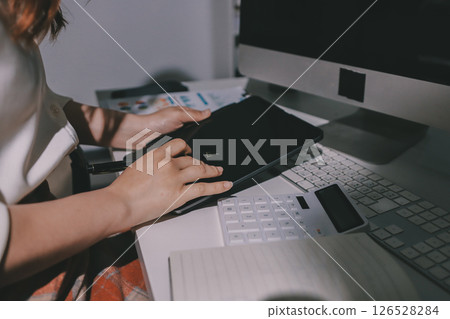 Expert woman asian female people review data number costing managerial account prepare monthly actual cost variance report at tax audit office. ESG sheet budget control ERP process service project. 126528284