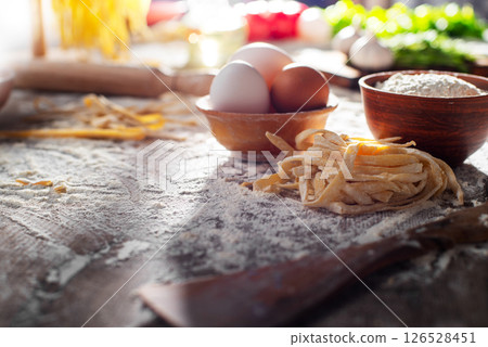 Portion of homemade noodles on floured kitchen table cooking background 126528451