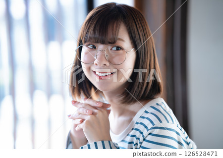 A young woman wearing glasses 126528471