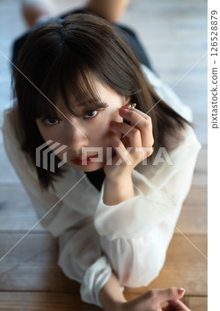 Young woman lying on flooring Young woman lying on flooring 126528879