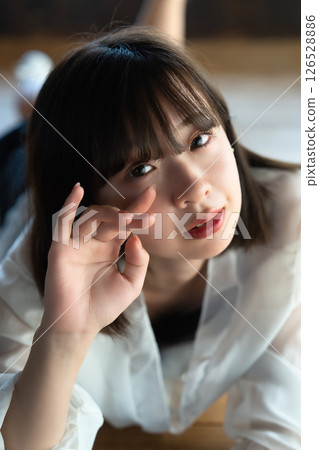Young woman lying on flooring 126528886