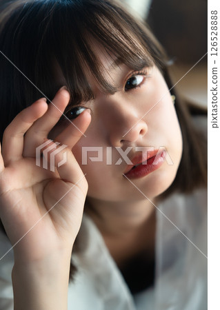 Young woman lying on flooring Young woman lying on flooring 126528888