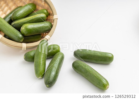 Mini cucumbers served in a small colander Mini cucumbers served in a small colander 126529312